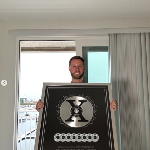 Kyle Koschel with his ClickFunnels Eight Figure Club award